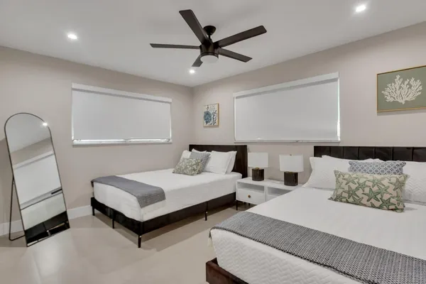 a spacious bedroom with a bed and a chandelier