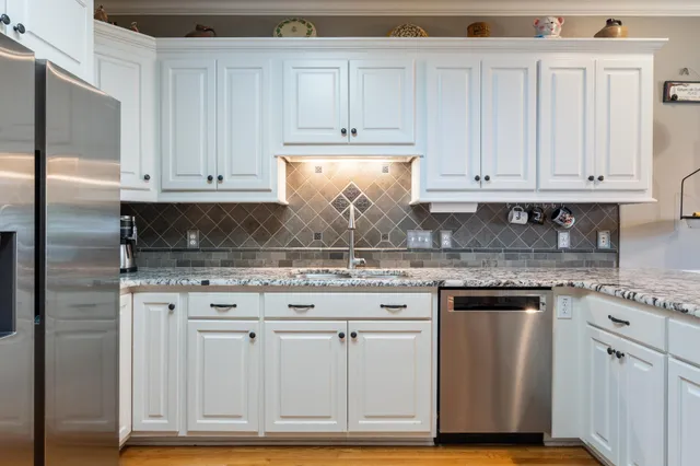 a kitchen with stainless steel appliances granite countertop a stove and a microwave