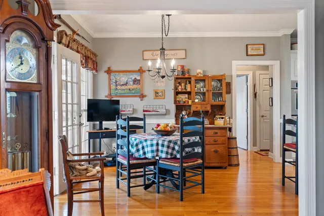 a bedroom with a large bed and a chandelier
