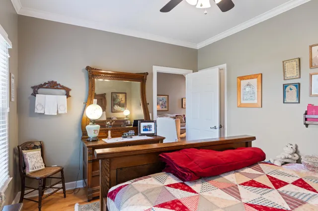 a bedroom with a bed and a chandelier