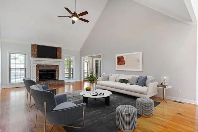 wooden floor fireplace and windows in an empty room