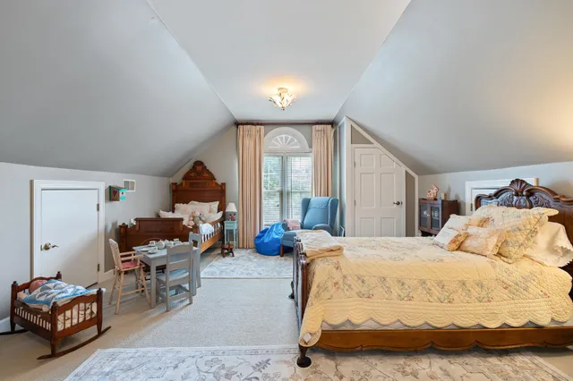 a bedroom with three beds and a large window
