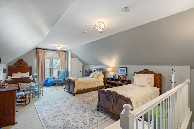 a large bedroom with a bed and furniture