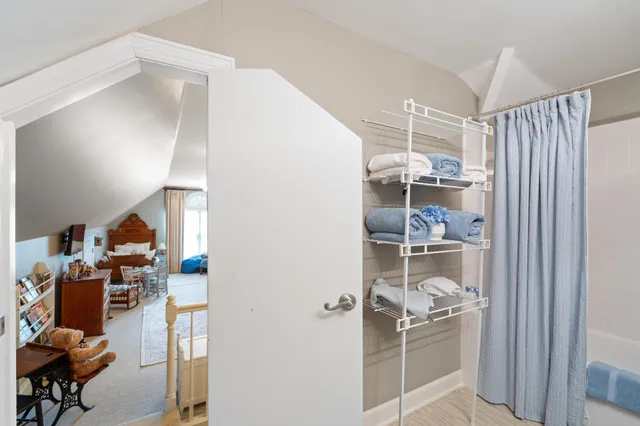 a bathroom with a granite countertop sink a toilet and shower