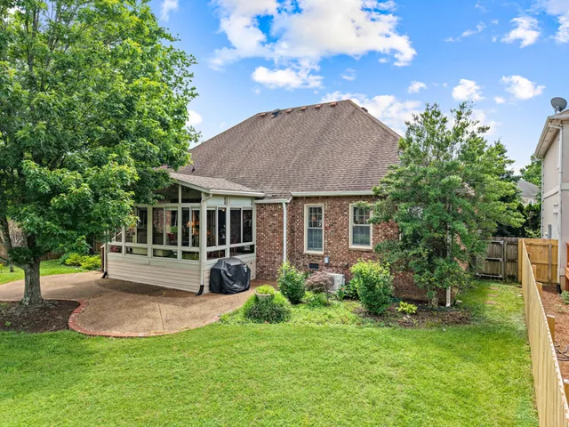 a view of a garden with a house