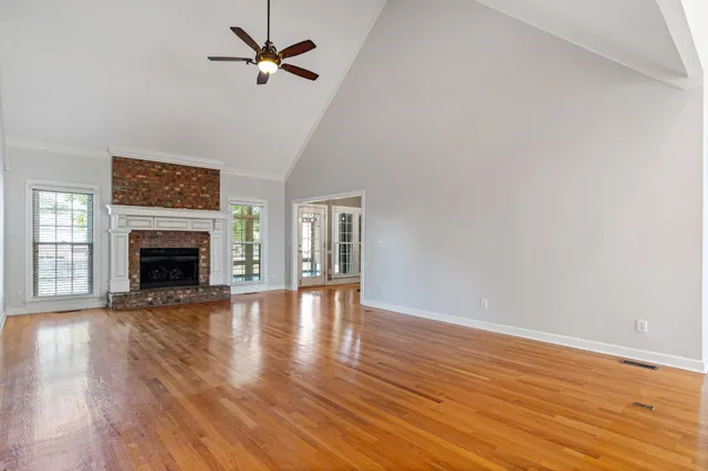 wooden floor in an empty room with a fireplace