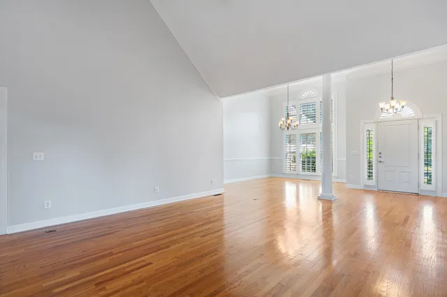 a view of a room with wooden floor chandelier and livingroom