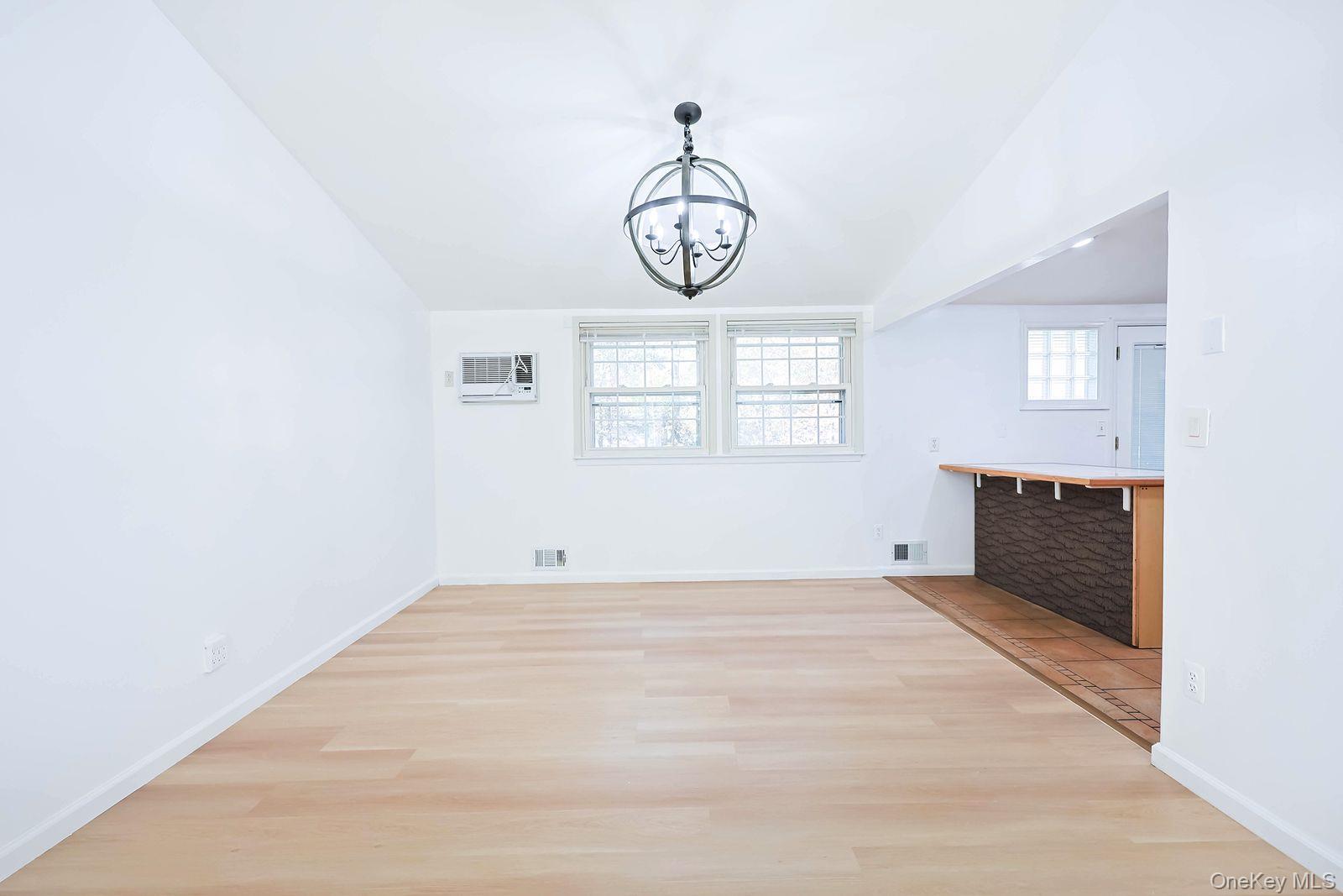 15 Mayflower Lane East Setauket, NY 11733 - Photo 14 of 23 a view of an empty room with wooden floor and window