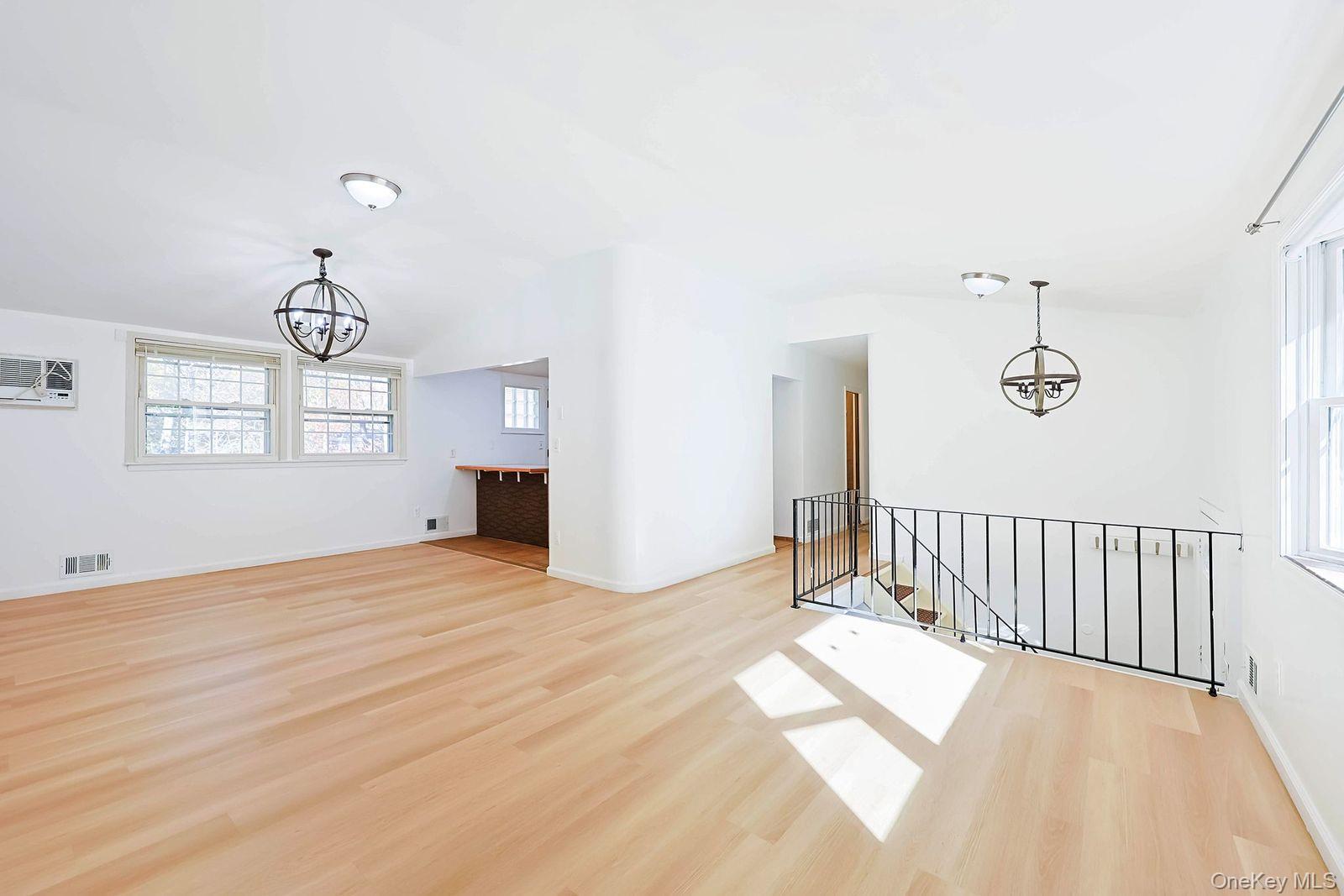 15 Mayflower Lane East Setauket, NY 11733 - Photo 16 of 23 a view of an empty room with wooden floor and windows