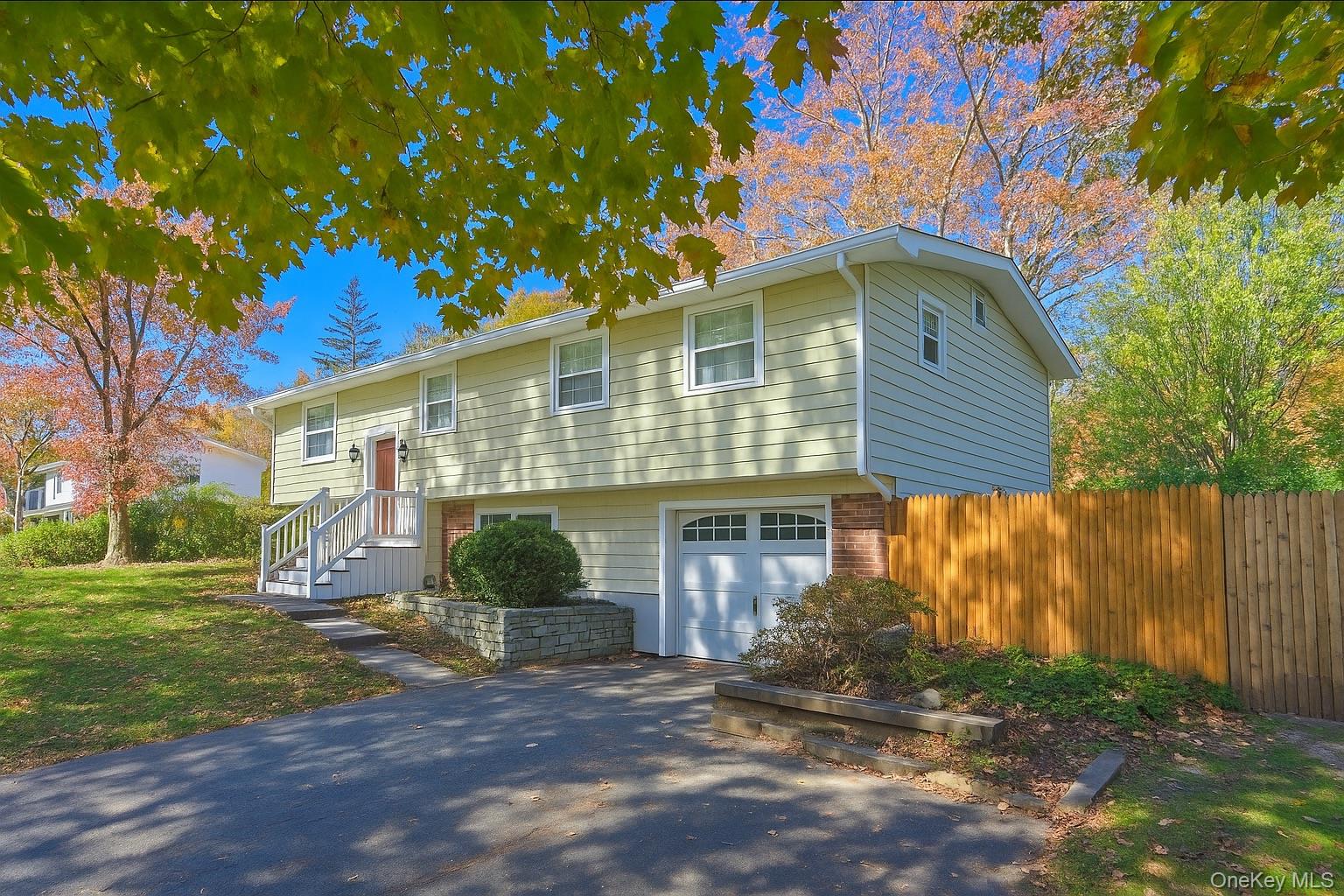 15 Mayflower Lane East Setauket, NY 11733 - Photo 2 of 23 a front view of a house with a yard and garage