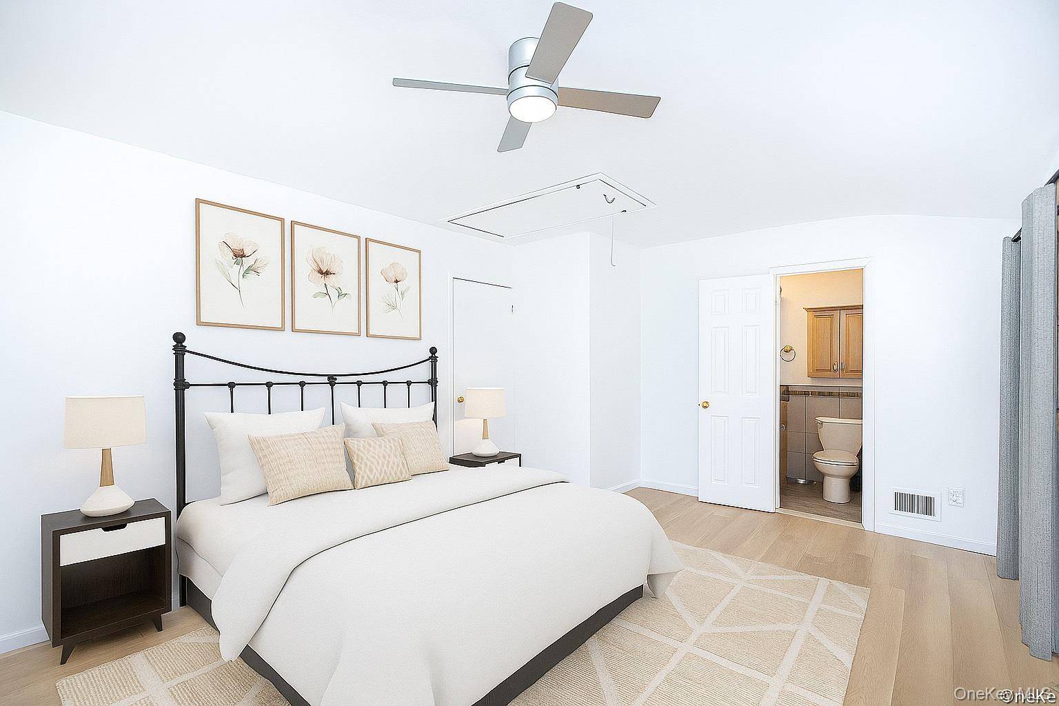 15 Mayflower Lane East Setauket, NY 11733 - Photo 21 of 23 a bedroom with a large bed and a chandelier