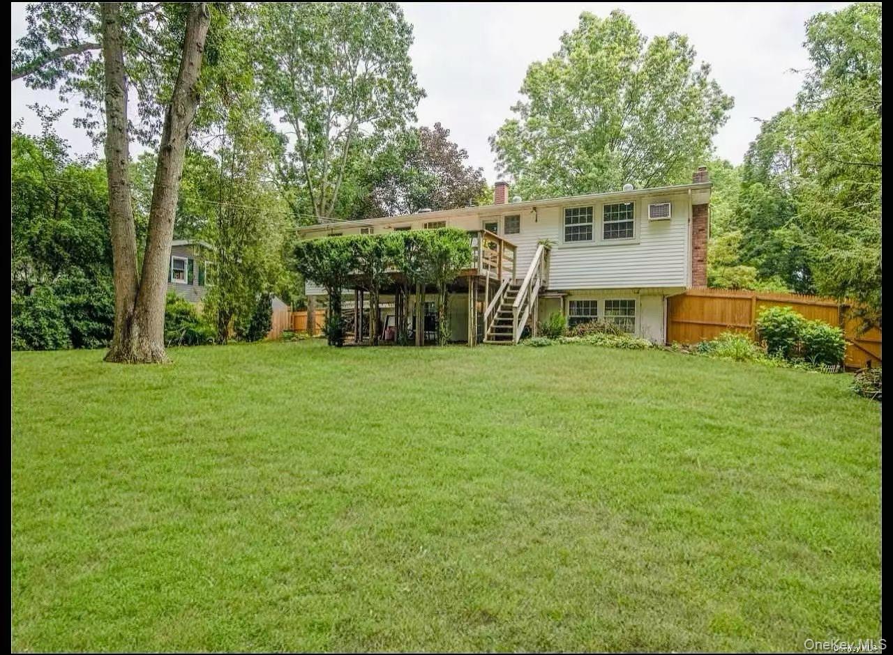 15 Mayflower Lane East Setauket, NY 11733 - Photo 22 of 23 a view of a house with a yard and sitting area