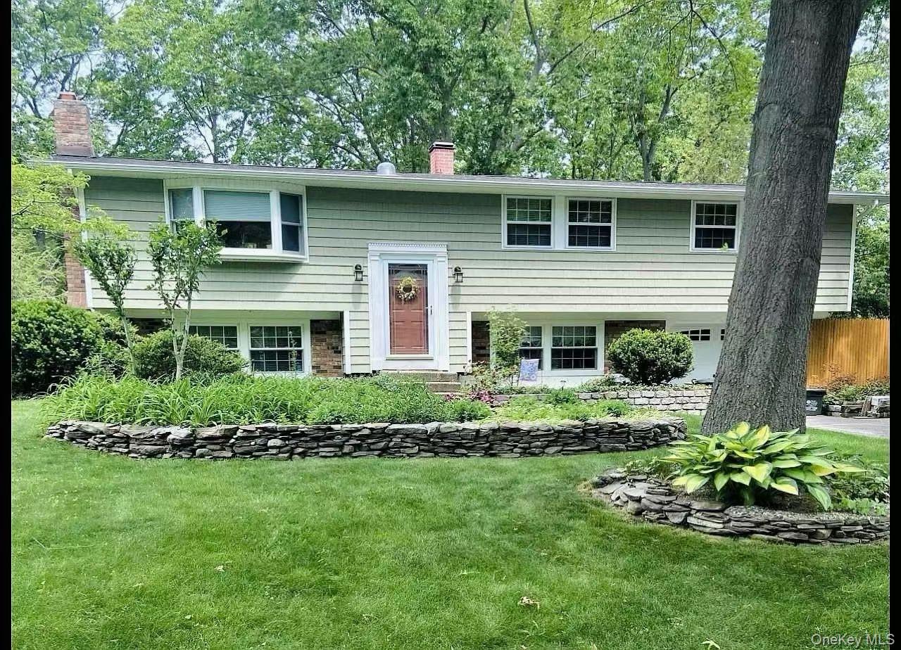 15 Mayflower Lane East Setauket, NY 11733 - Photo 3 of 23 a front view of a house with a garden