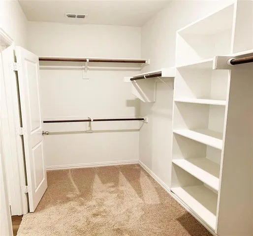 a view of an empty walk in closet