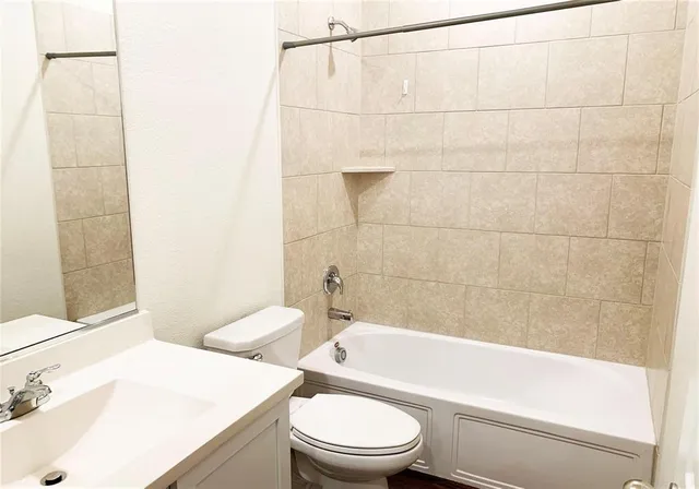 a bathroom with a sink a toilet and bathtub