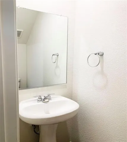 a bathroom with a sink a mirror and a shower