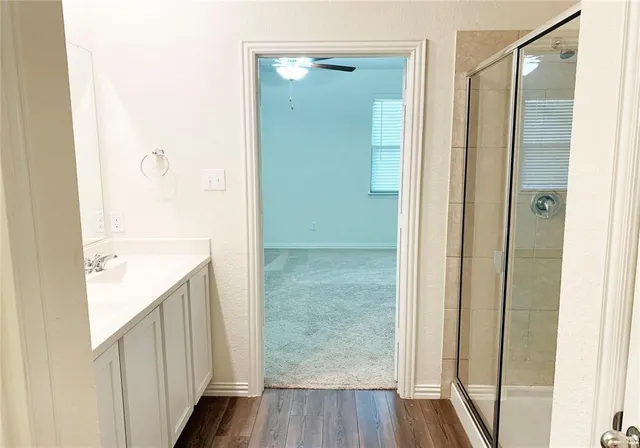 a bathroom with a shower and a mirror