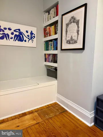 a bathroom with a bathtub and a painting on the wall