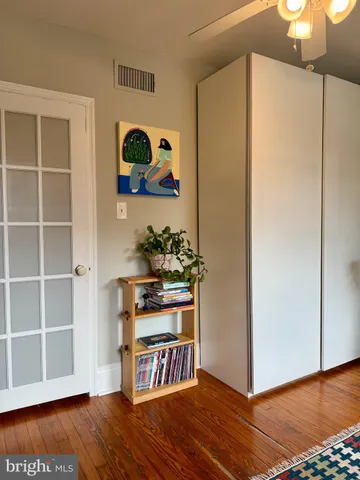 a view of kitchen with stainless steel appliances cabinets and wooden floor