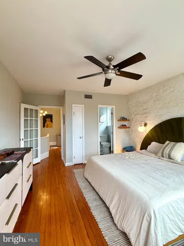 a spacious bedroom with a bed and ceiling fan