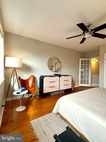 a bedroom with two beds and a chandelier