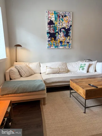 a bedroom with a bed and painting on the wall