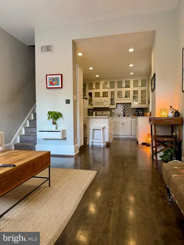 a living room with furniture and kitchen view