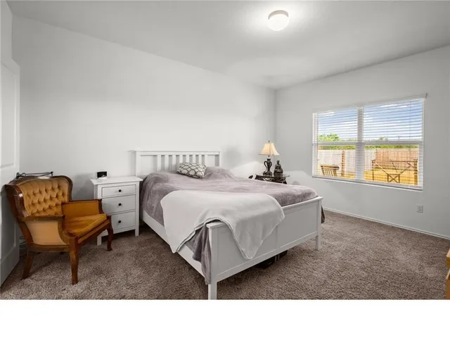 a living room with a bed furniture and a window