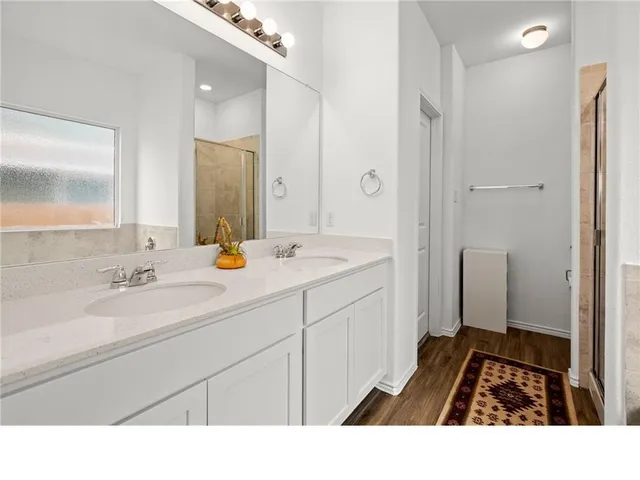 a bathroom with a sink a double vanity and a mirror