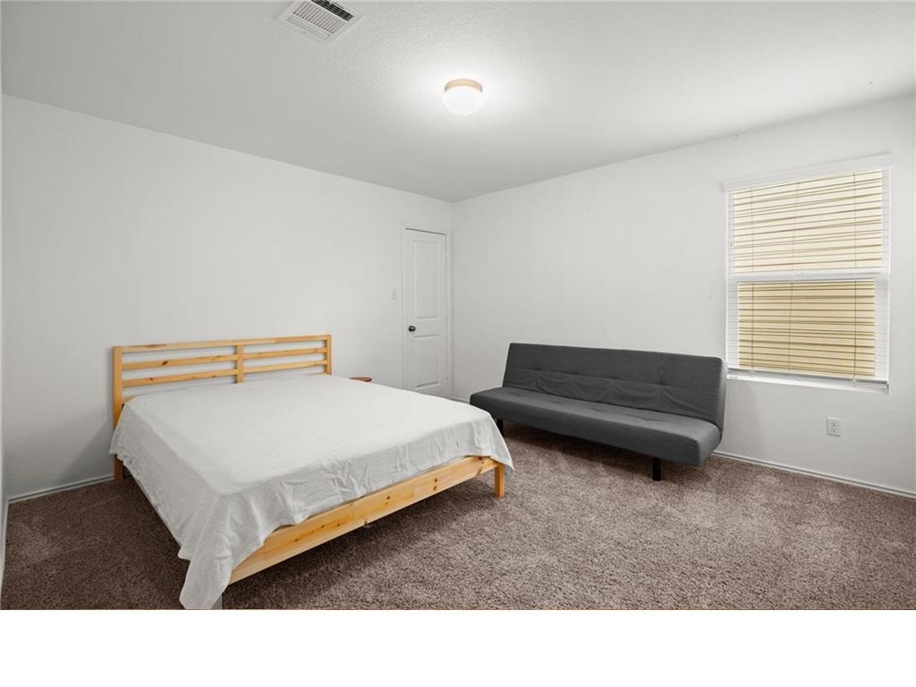 328 Majestic Cedar Court Liberty Hill, TX 78642 - Photo 25 of 31 a living room with a bed furniture and a window