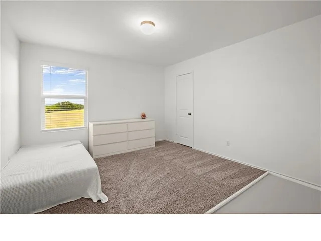 a living room with a bed furniture and a window