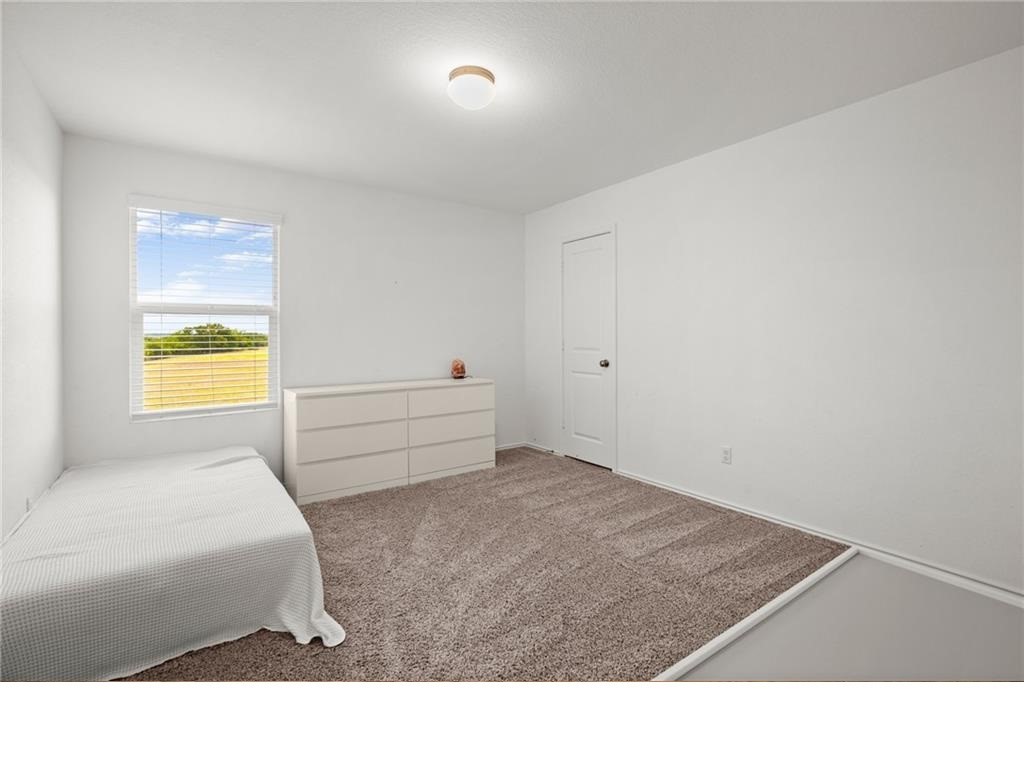 328 Majestic Cedar Court Liberty Hill, TX 78642 - Photo 28 of 31 a living room with a bed furniture and a window