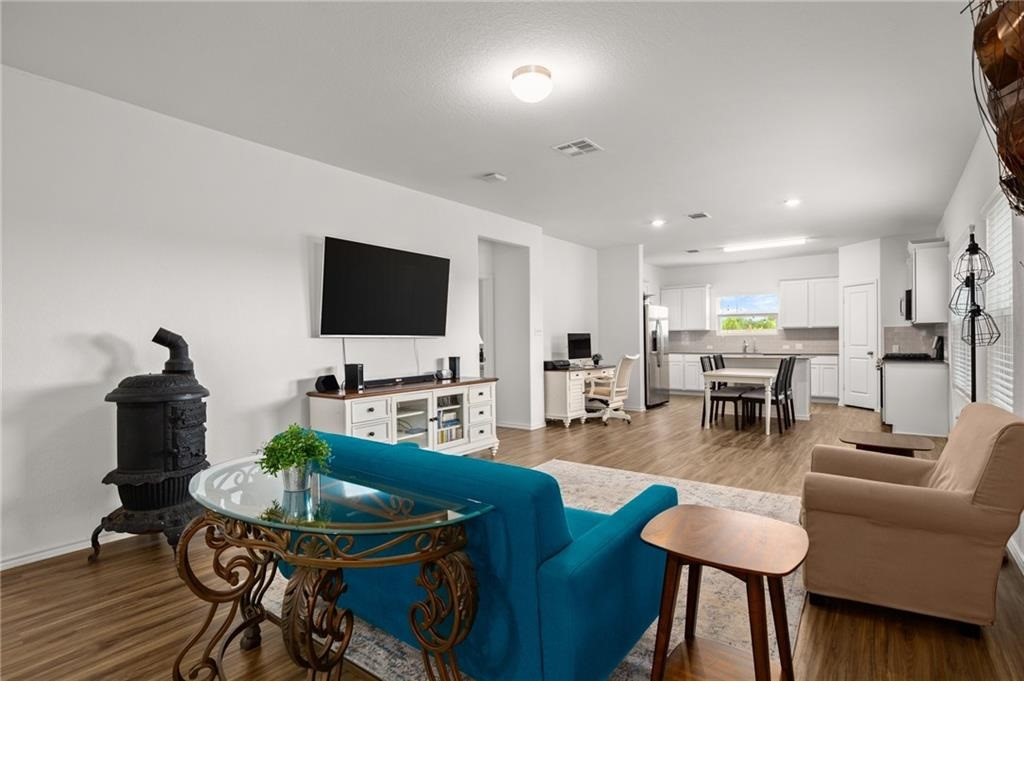 328 Majestic Cedar Court Liberty Hill, TX 78642 - Photo 4 of 31 a living room with furniture and a flat screen tv