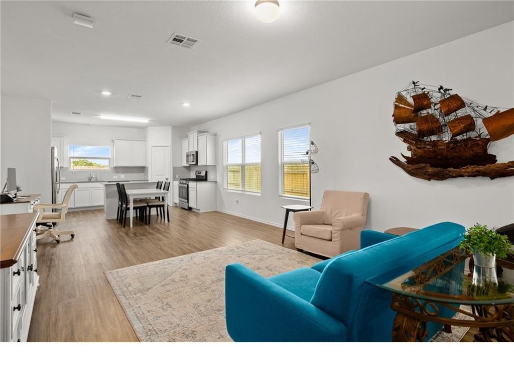 328 Majestic Cedar Court Liberty Hill, TX 78642 - Photo 6 of 31 a living room with furniture and a dining table