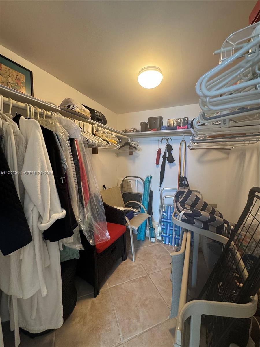 400 North Surf Road, Unit RGB Hollywood, FL 33019 - Photo 12 of 17 a view of walk in closet with clothes and shoes