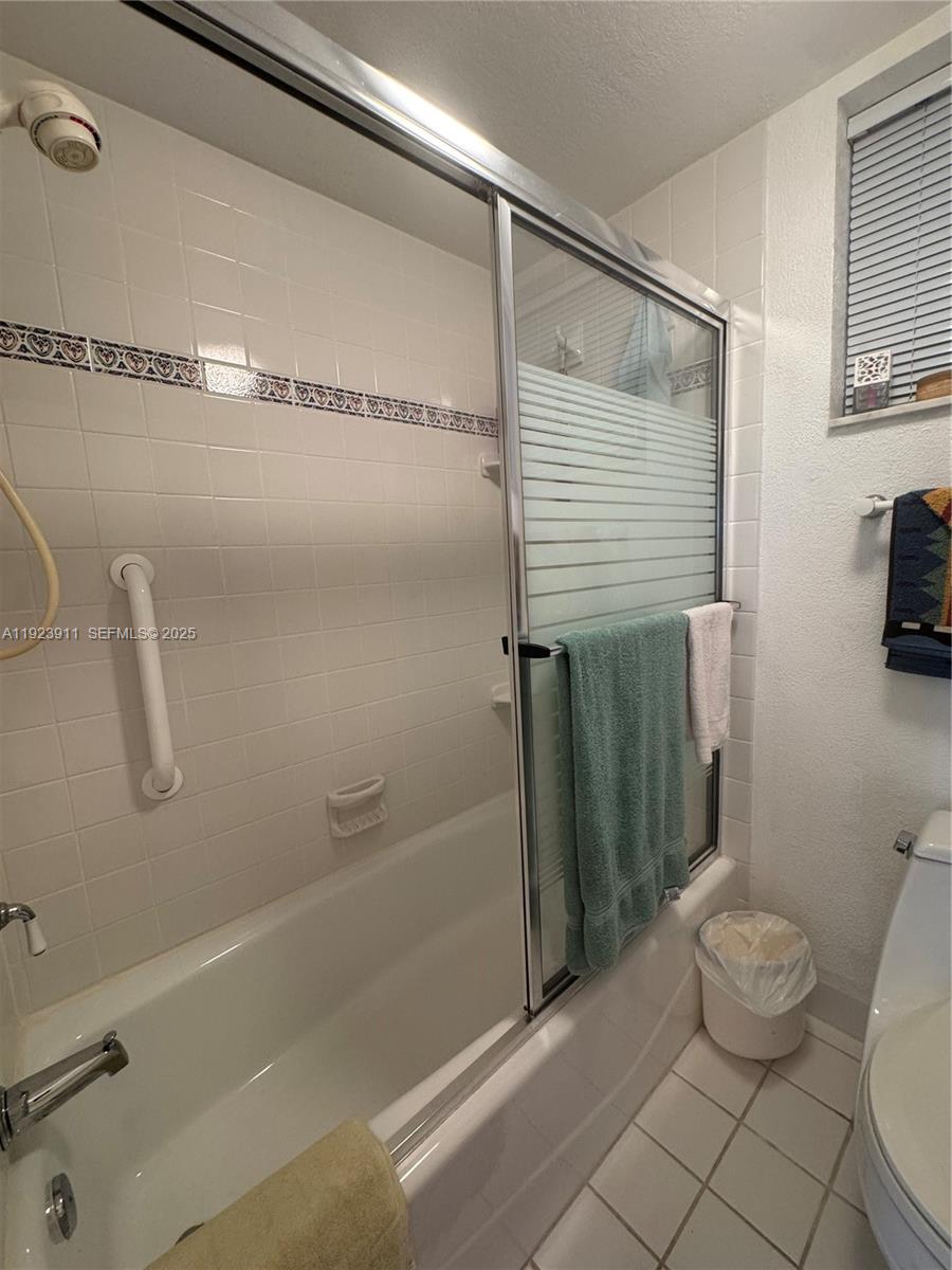 400 North Surf Road, Unit RGB Hollywood, FL 33019 - Photo 15 of 17 a bathroom with a granite countertop bathtub shower and toilet