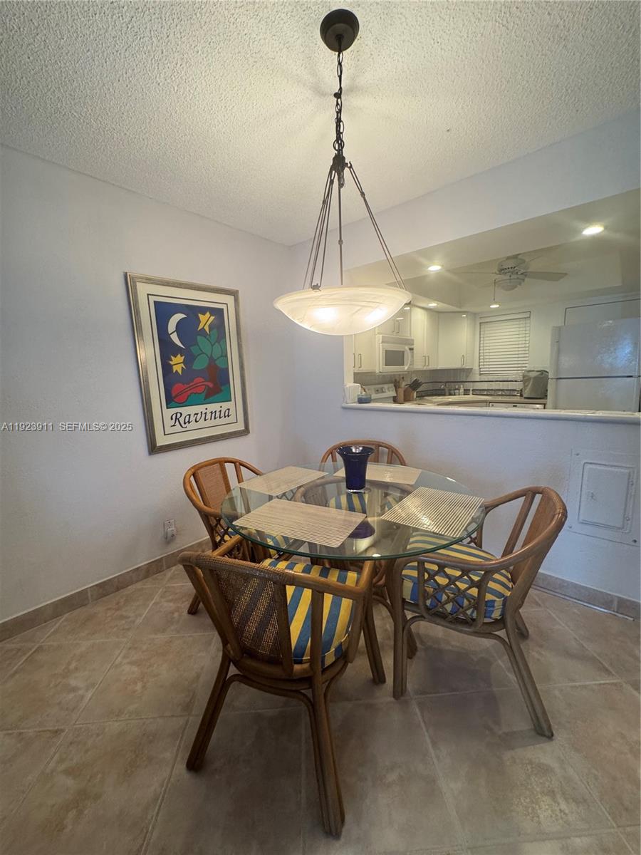 400 North Surf Road, Unit RGB Hollywood, FL 33019 - Photo 7 of 17 a dining room with a table and chairs