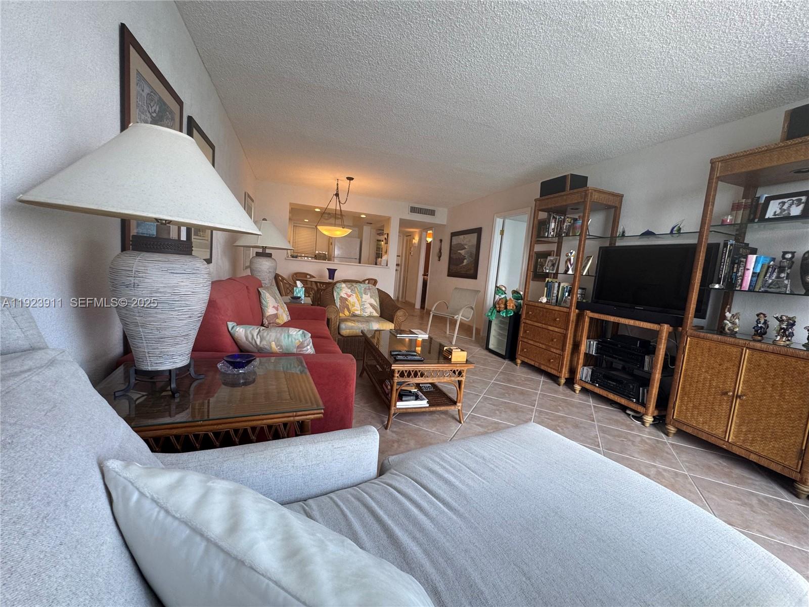 400 North Surf Road, Unit RGB Hollywood, FL 33019 - Photo 8 of 17 a living room with furniture and a flat screen tv