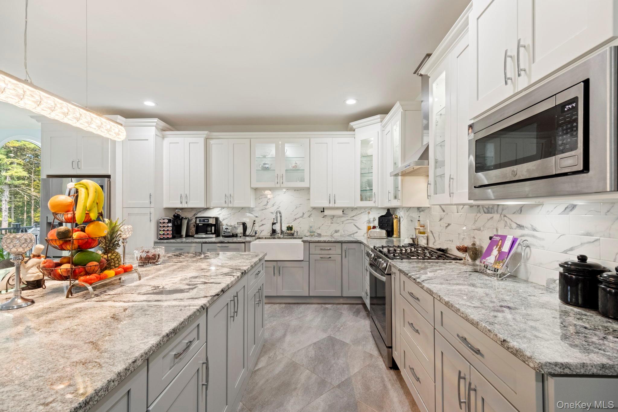 174 Webber Road Coxsackie, NY 12058 - Photo 14 of 50 a kitchen with stainless steel appliances granite countertop a sink dishwasher stove and microwave with wooden cabinets