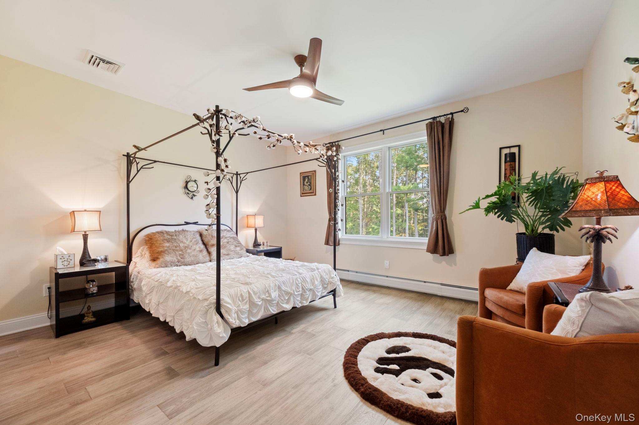 174 Webber Road Coxsackie, NY 12058 - Photo 27 of 50 a bedroom with a bed a couch and a window