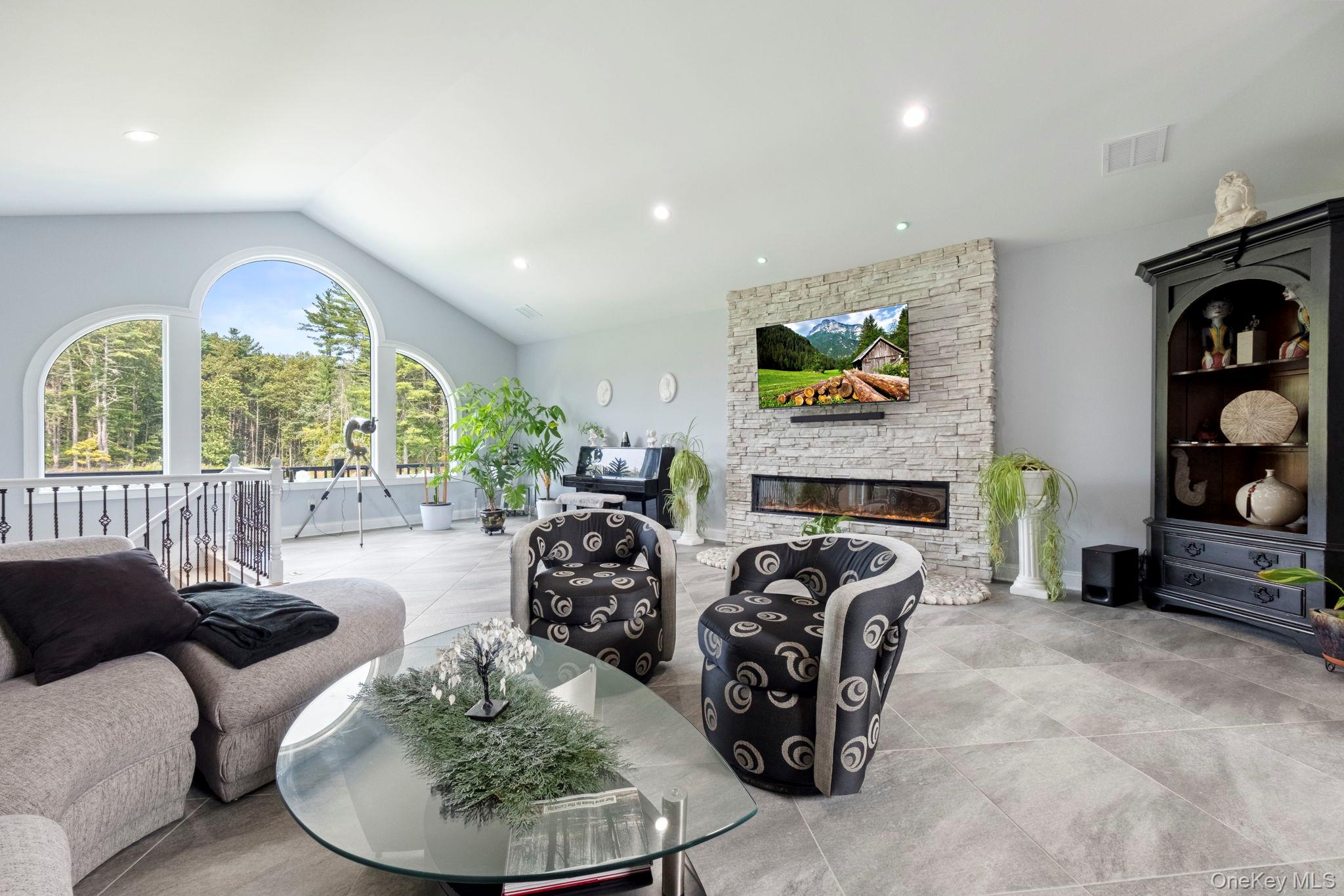 174 Webber Road Coxsackie, NY 12058 - Photo 8 of 50 a living room with fireplace furniture and a floor to ceiling window