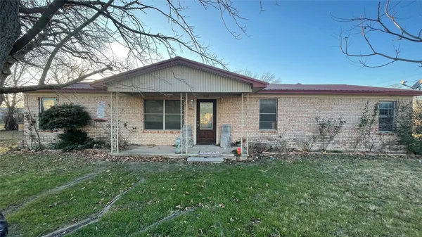 a front view of house with yard and outdoor seating