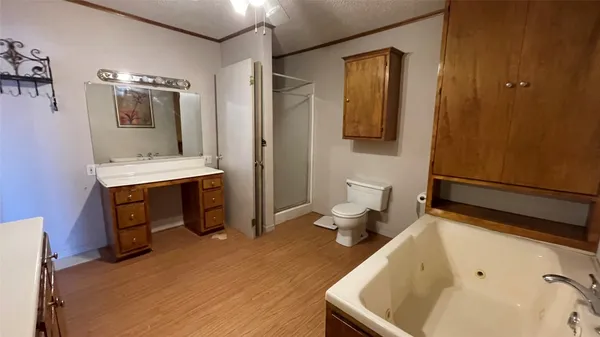 a bathroom with a tub sink and mirror