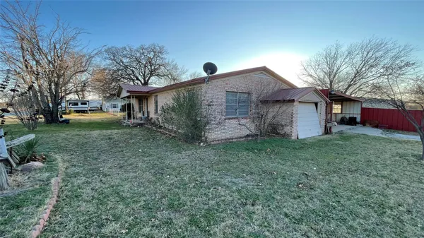 a front view of house with yard and trees