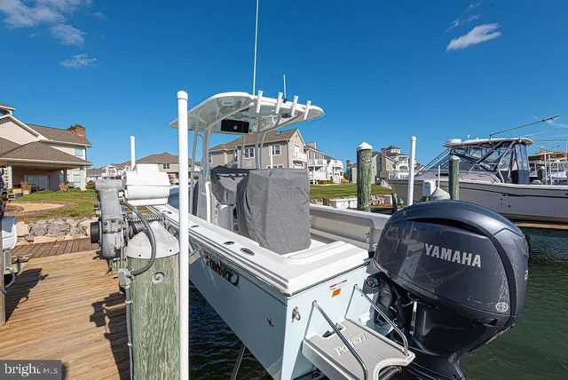 a kitchen with stainless steel appliances kitchen island granite countertop a sink a stove a dining table and chairs