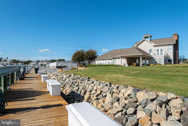 a kitchen with stainless steel appliances white cabinets and a large window