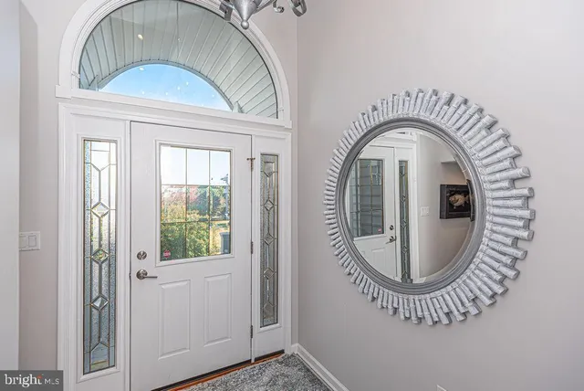 a balcony with wooden floor table and chairs