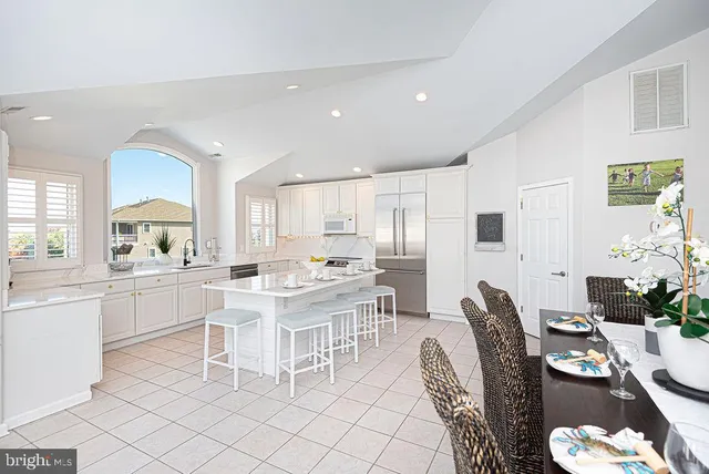 a spacious bedroom with a bed and a chandelier