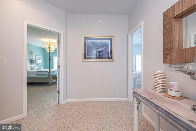 an aerial view of a city with lots of residential buildings ocean and mountain view in back