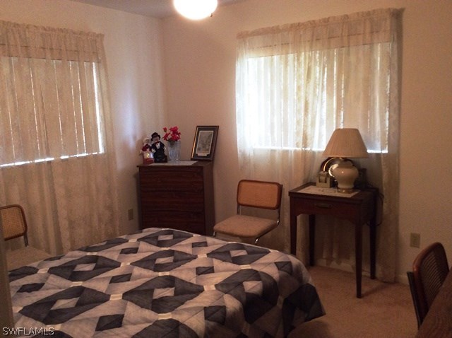 225 Danby Road Lehigh Acres, FL 33936 - Photo 16 of 20 a bedroom with a bed and a window